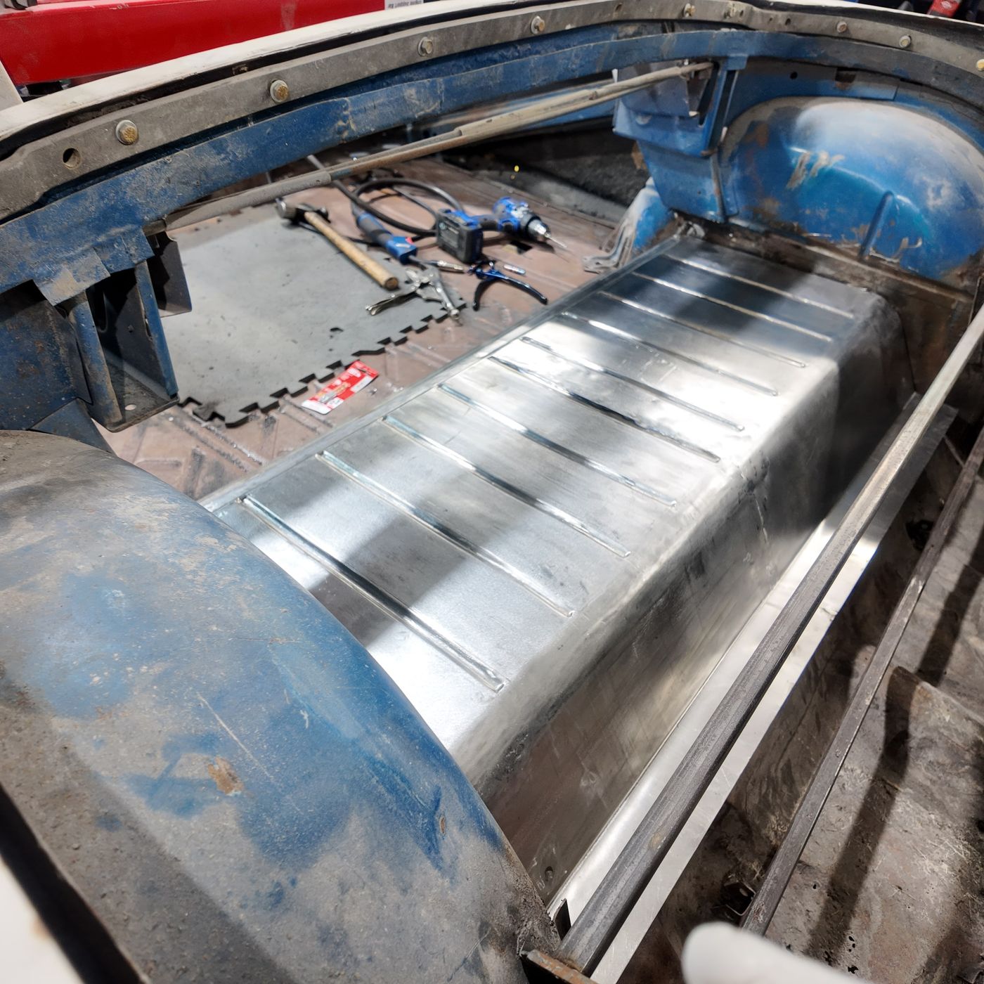 New ribbed trunk floor pan installed in the 1958 Impala between the rear wheel wells